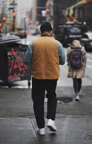 a man walking down a street with a backpack