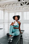 a woman sitting on top of a black mat