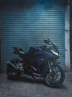 A sleek motorcycle parked outside Bikers Pitstop under moody lighting, highlighting the shop's modern vibe.