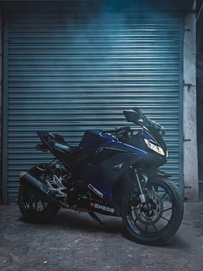A sleek motorcycle parked outside Bikers Pitstop under moody lighting, highlighting the shop's modern vibe.