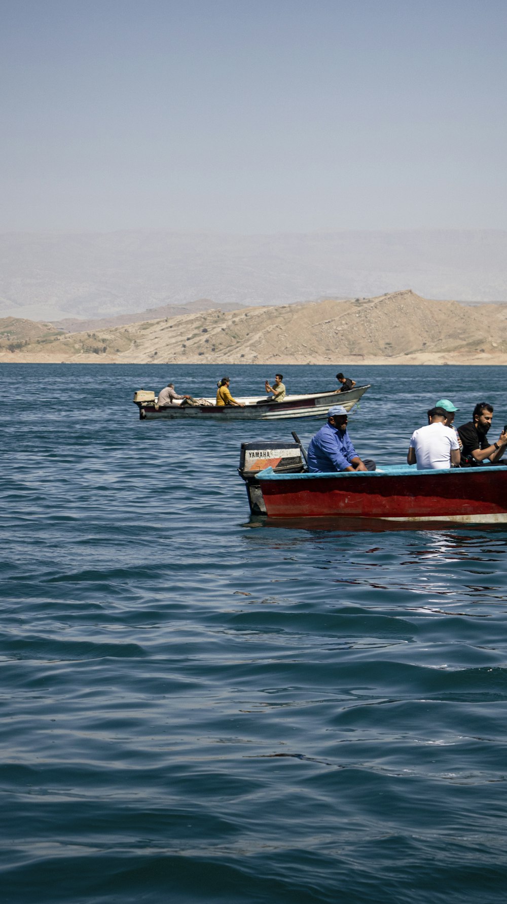a group of people in a small boat on the water