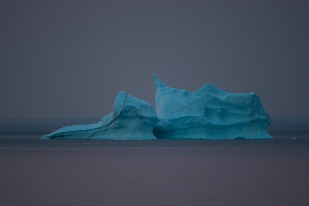 a large iceberg floating in the middle of the ocean