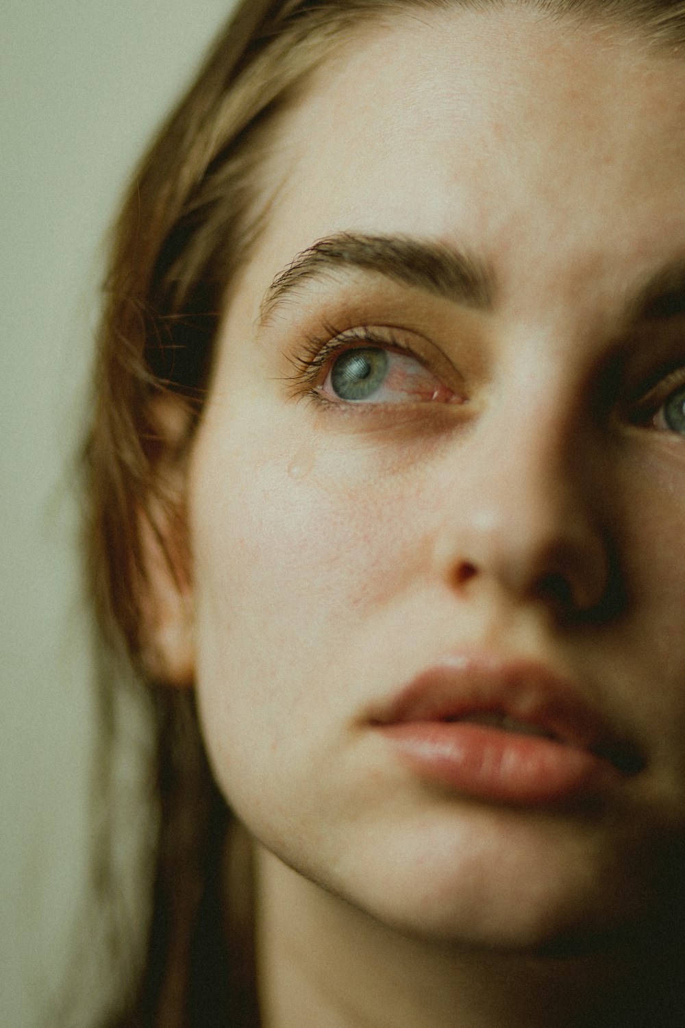 a close up of a woman with blue eyes