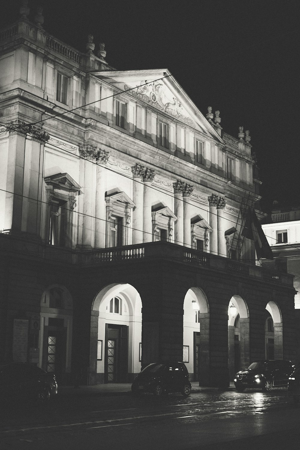 a black and white photo of a building at night