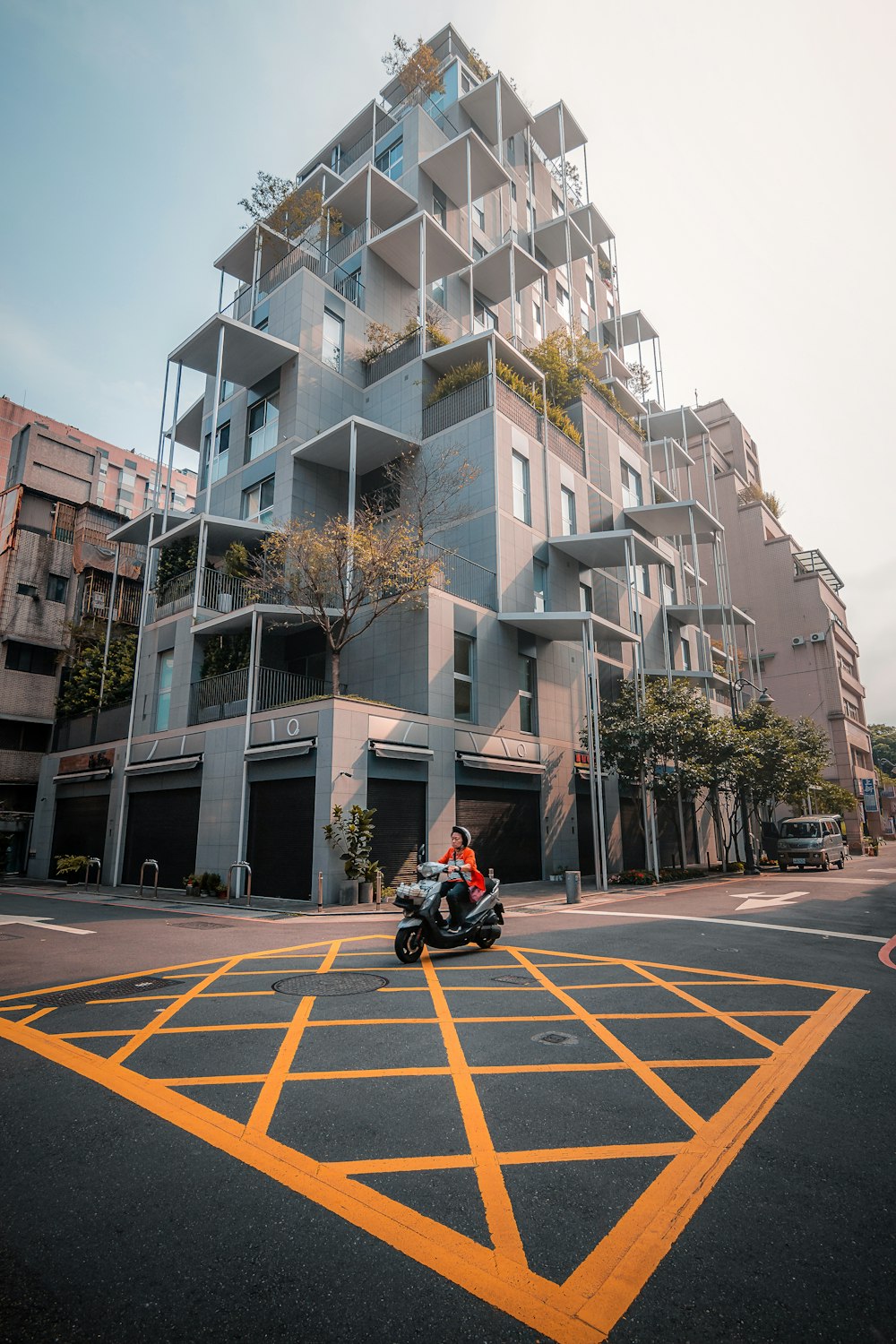 a motorcycle parked in front of a tall building