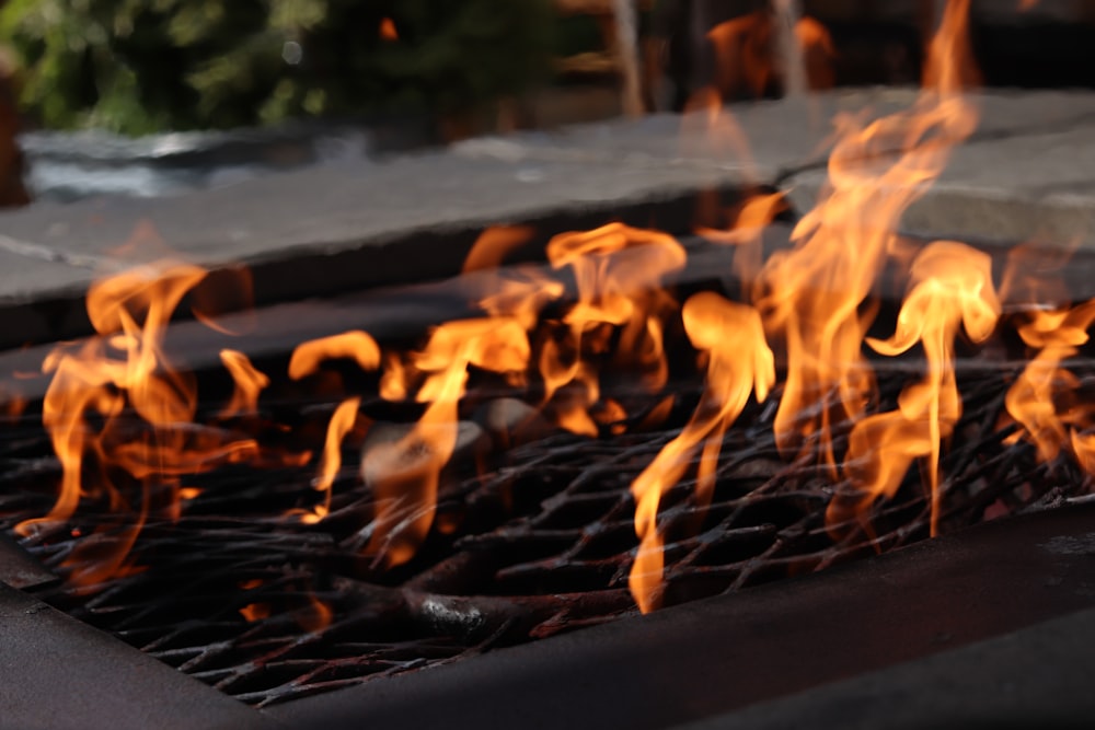 a close up of a grill with flames