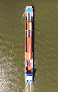 a large boat with a lot of colorful containers on it