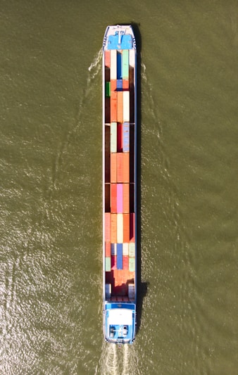 a large boat with a lot of colorful containers on it