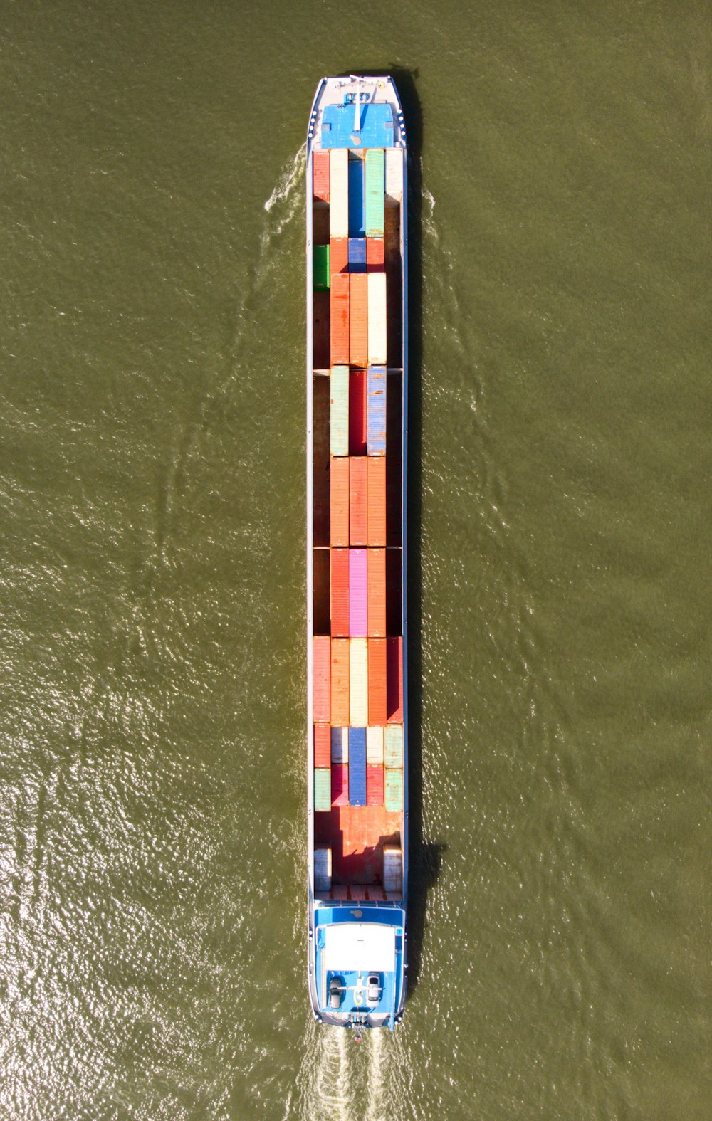 a large boat with a lot of colorful containers on it