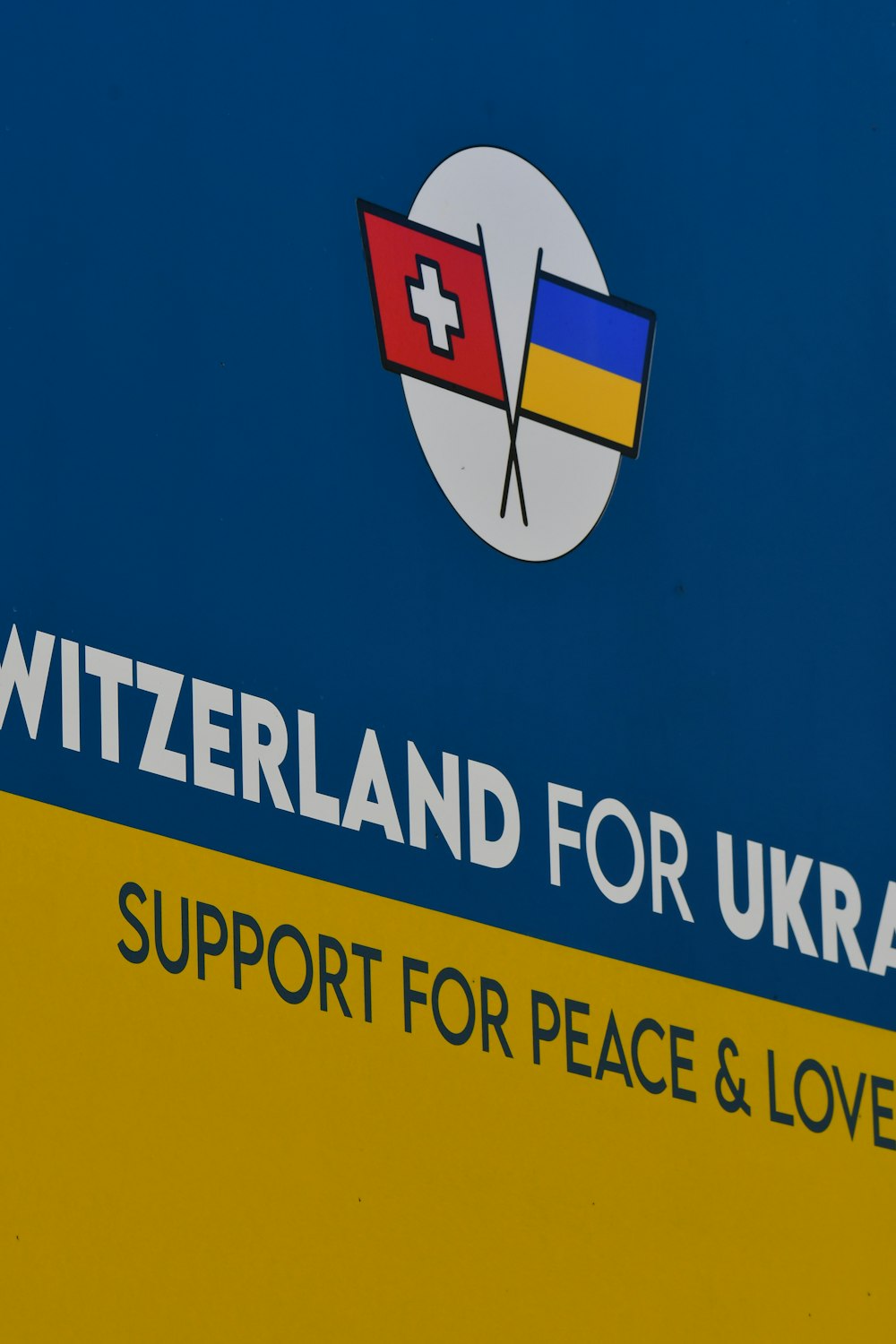 a blue and yellow sign with a flag on it
