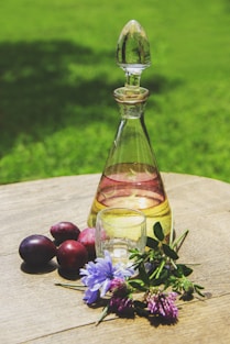 a bottle of oil sitting on top of a wooden table
