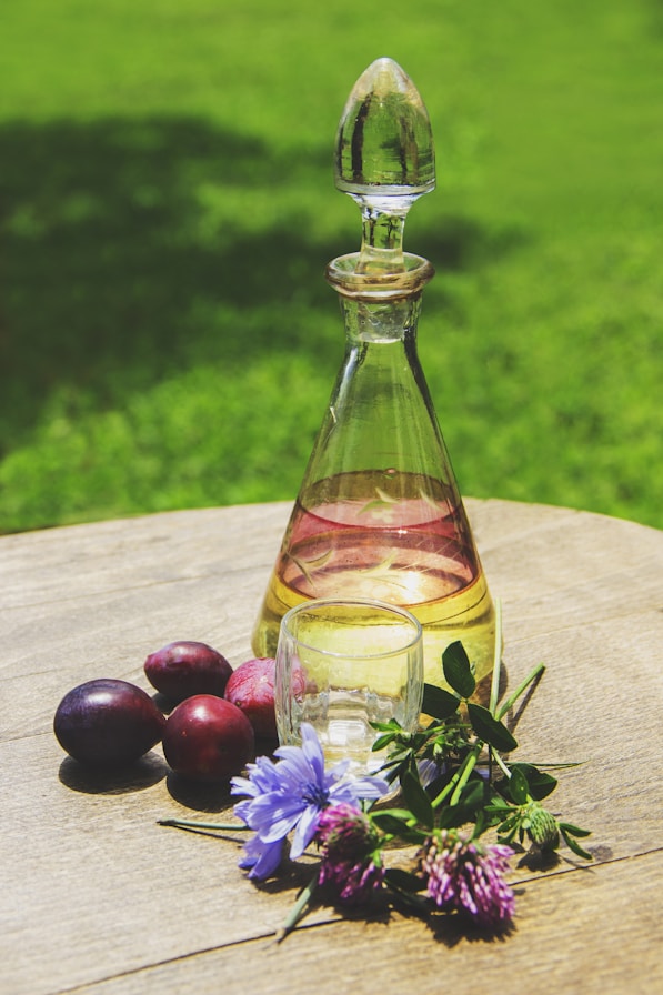 a bottle of oil sitting on top of a wooden table