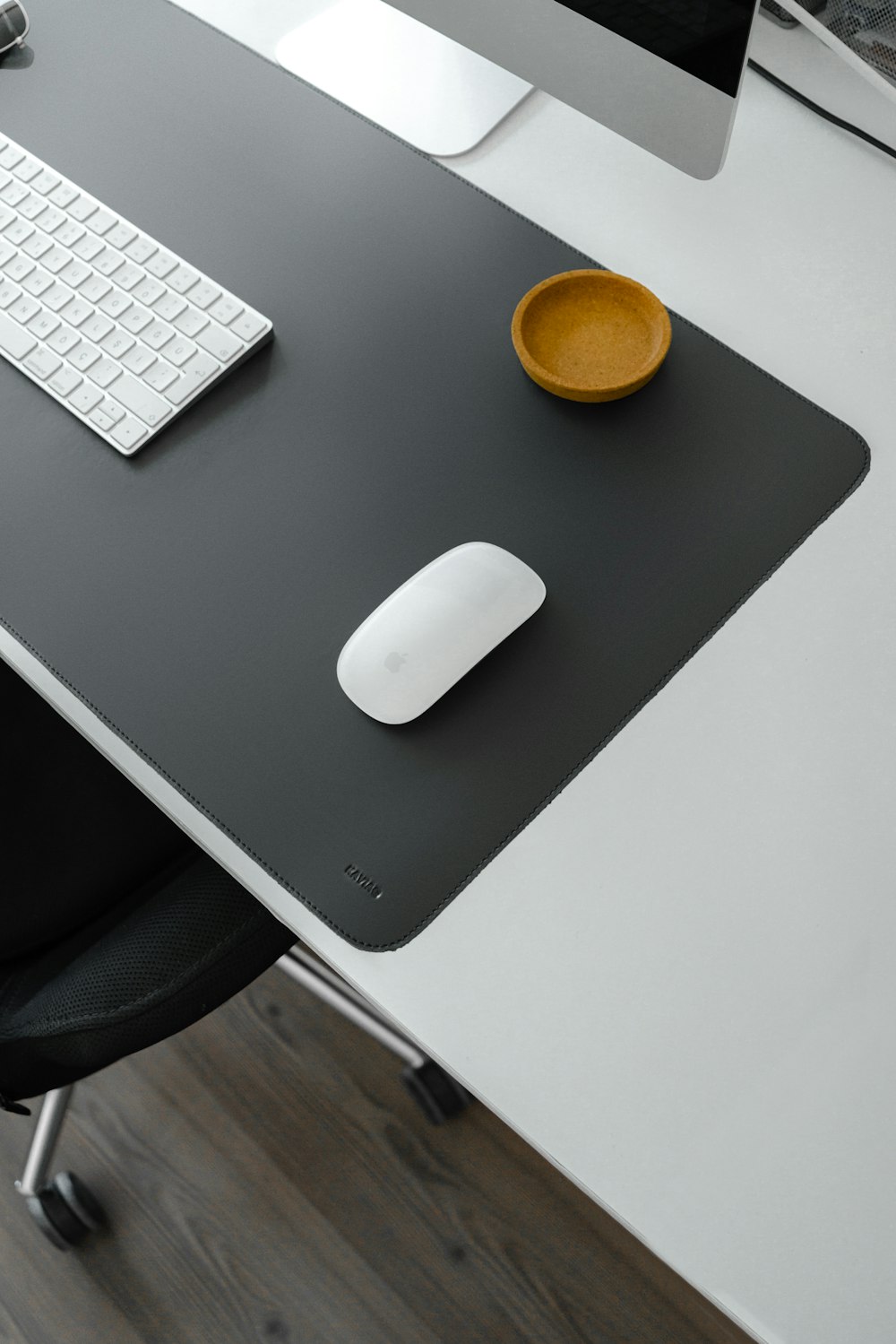 a computer desk with a mouse and keyboard on it