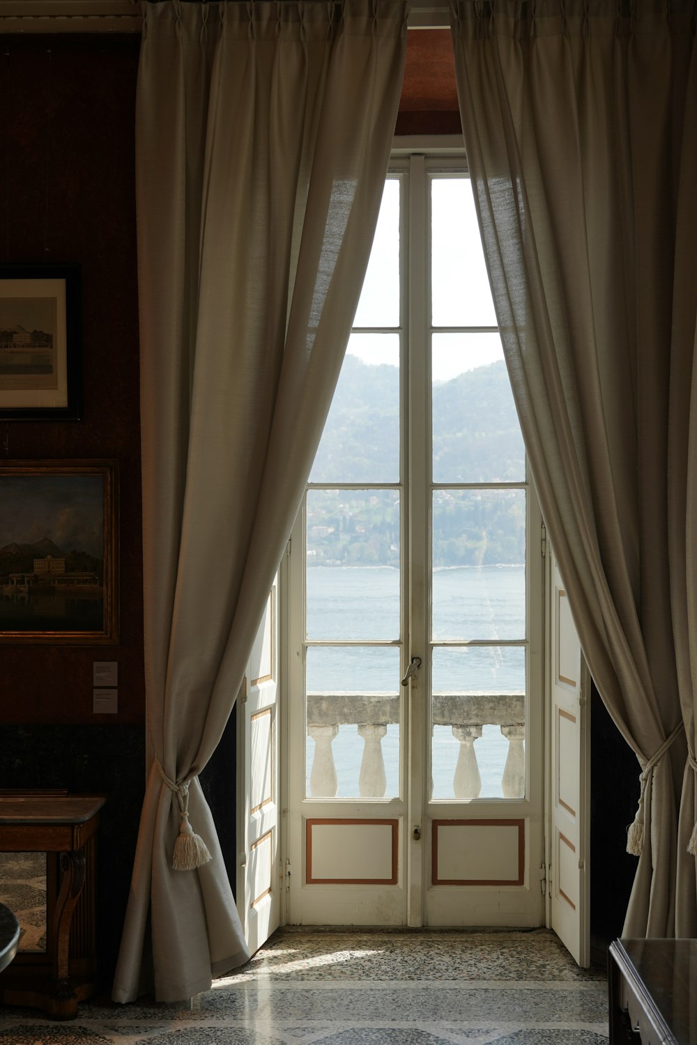 an open window with a view of a body of water