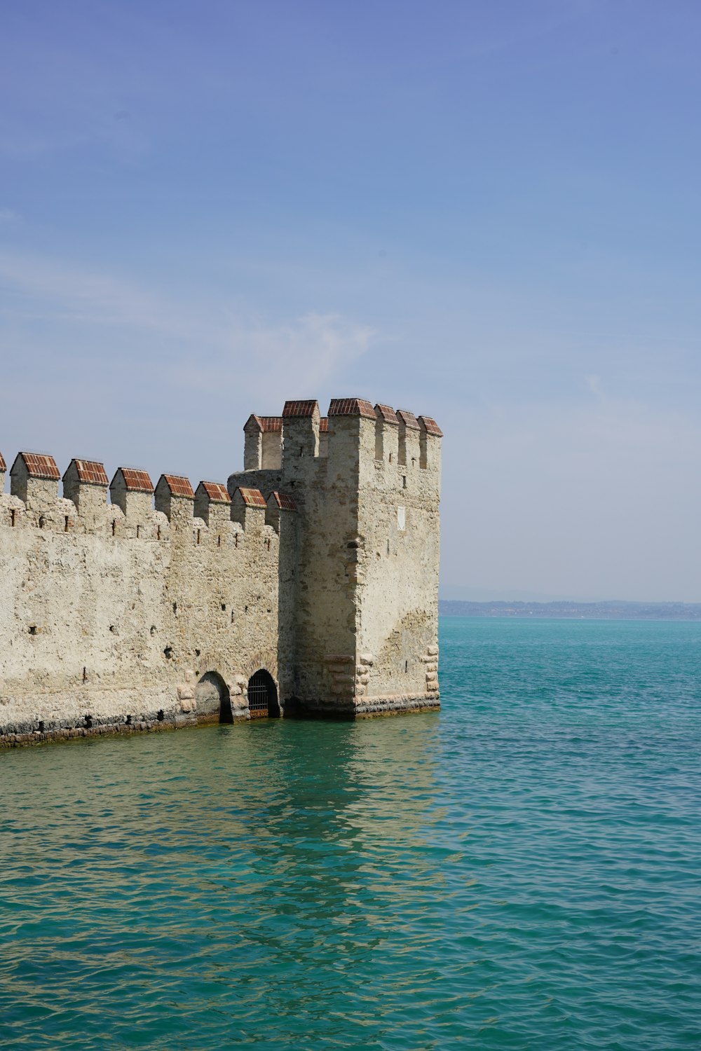 a large castle sitting on top of a body of water