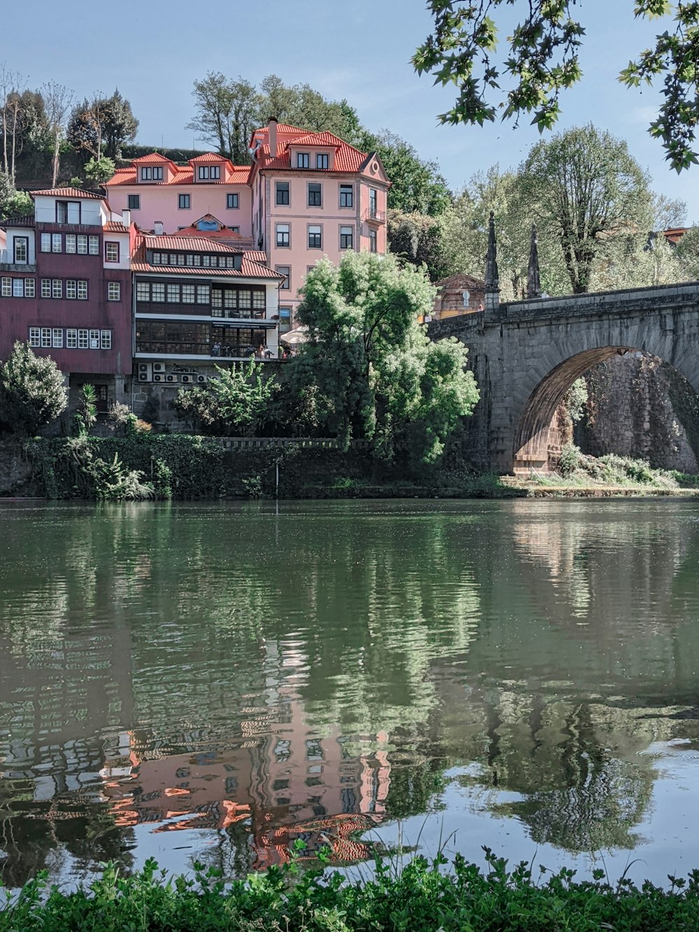 a bridge over a body of water with buildings in the background