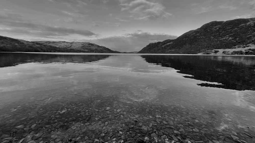 a body of water with mountains in the background