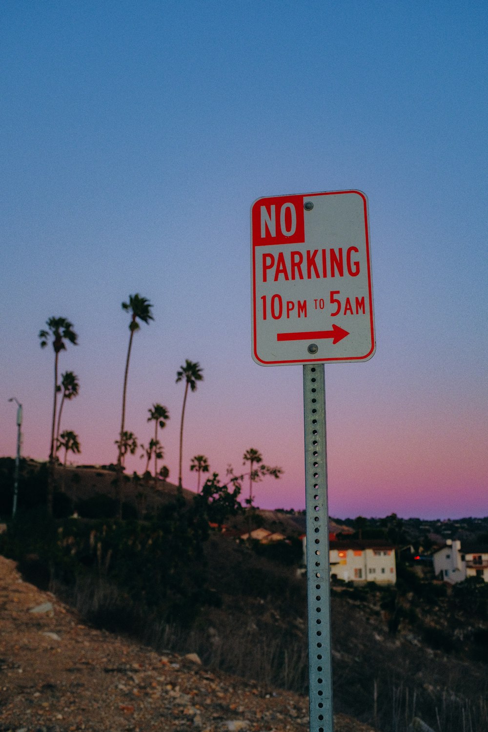 a no parking sign on the side of a road