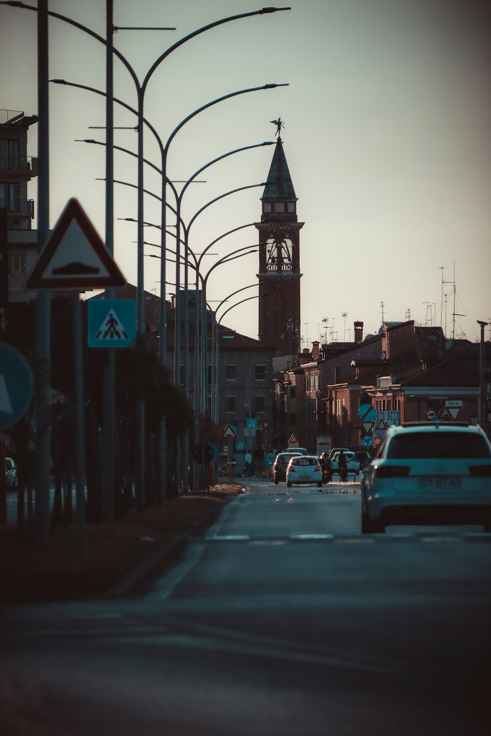 a city street with a clock tower in the background