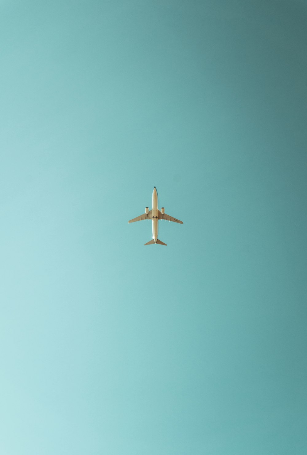 an airplane is flying in the blue sky