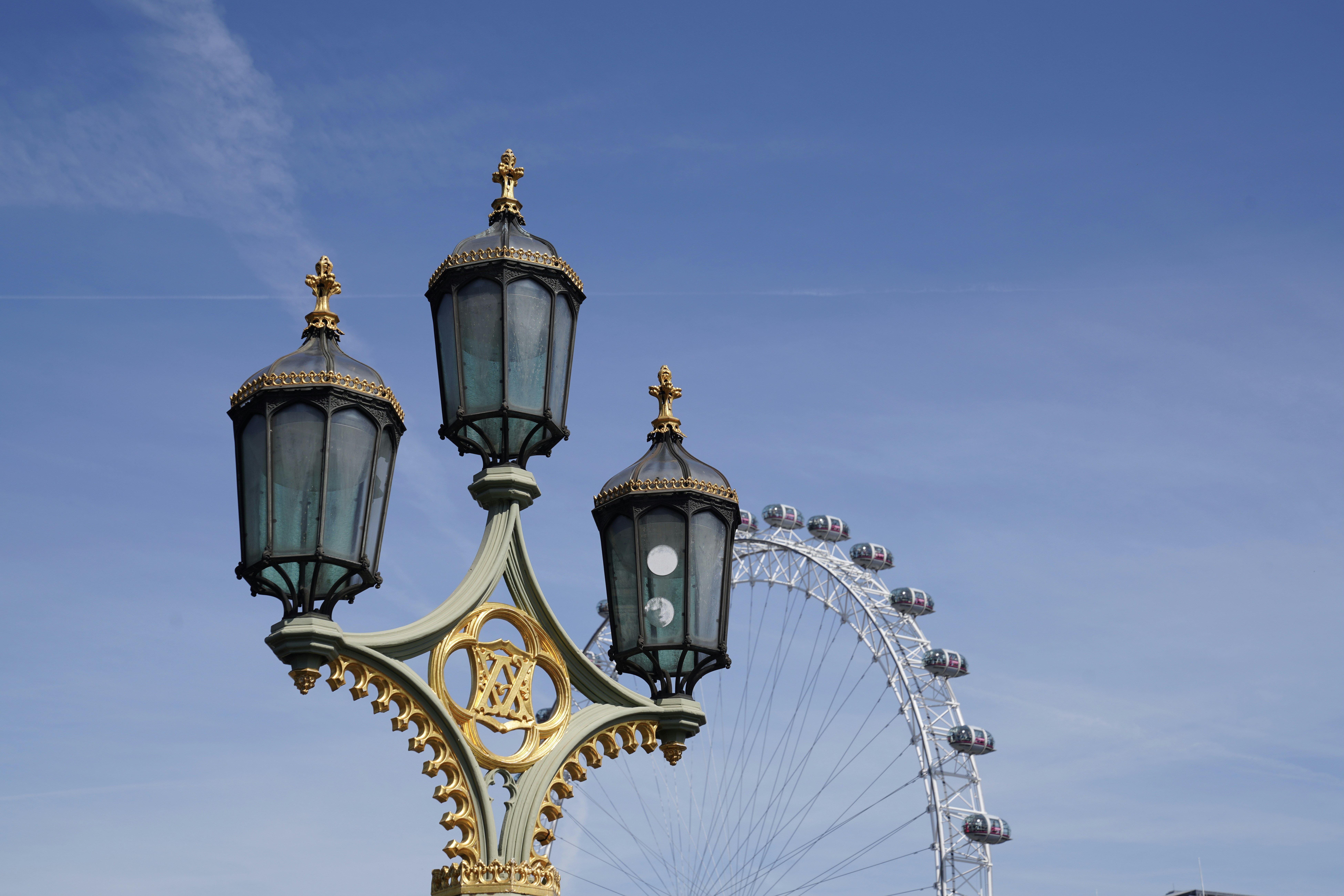 a street light with a ferris wheel in the background