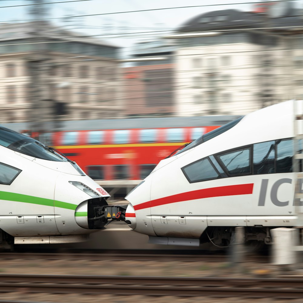 two white trains passing each other on a track