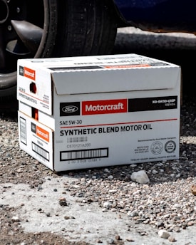 a box sitting on the ground next to a car