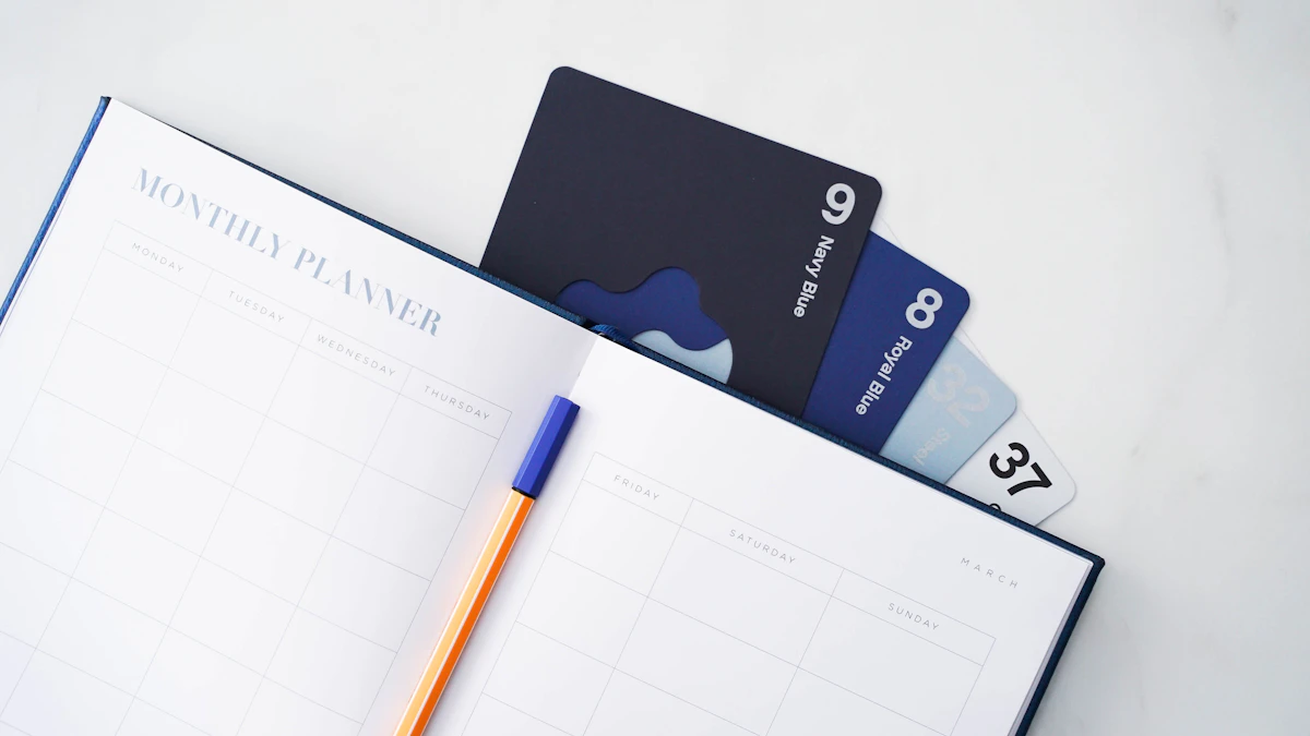 Open monthly planner with a pen and two bank cards tucked into the page