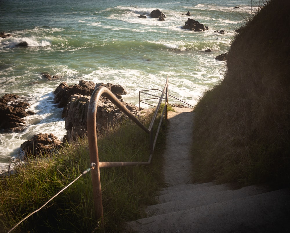 a stairway leading down to the ocean with a view of the ocean