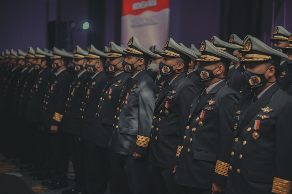 a group of men in military uniforms standing in a row