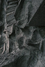 High-resolution image of a rugged stone being precisely cut by advanced machinery in a modern industrial setting.
