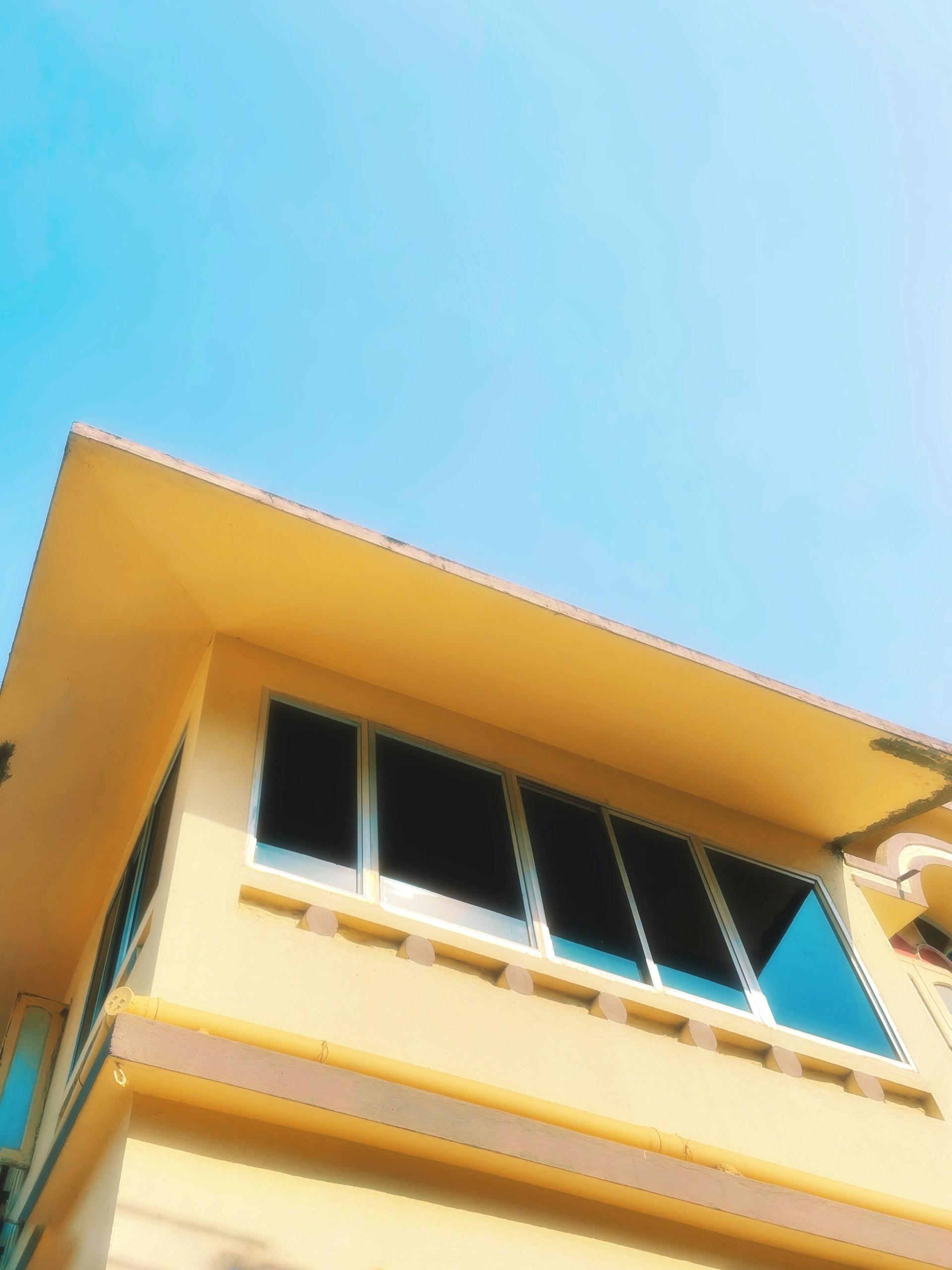 woman wearing yellow long-sleeved dress under white clouds and blue sky during daytime