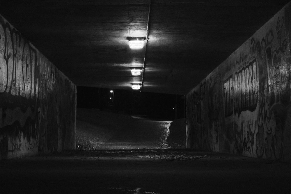 a black and white photo of a dark tunnel