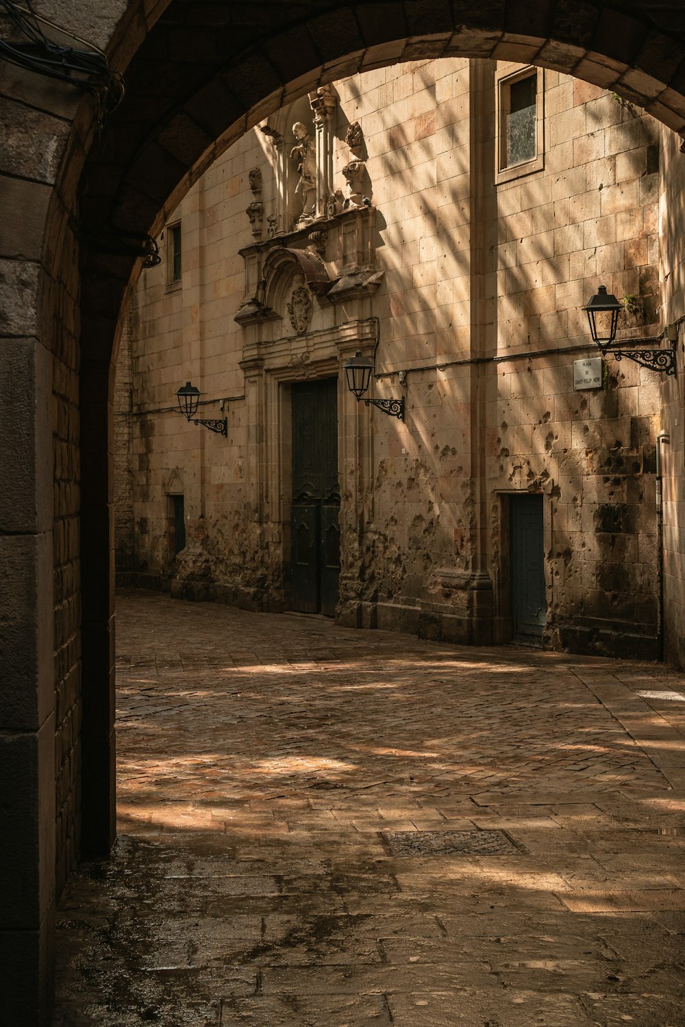 an archway leading to a building with a clock on it