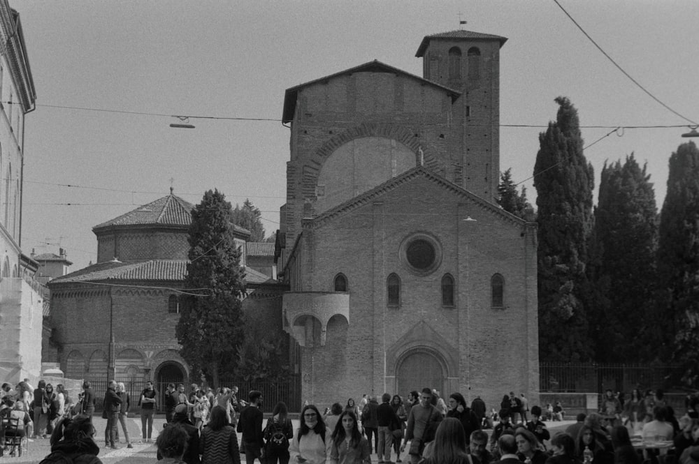 a large group of people standing around a church