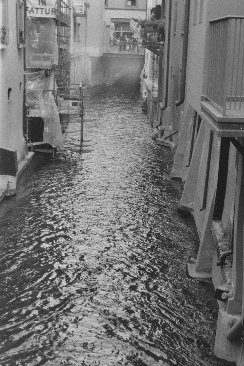 a black and white photo of a flooded street