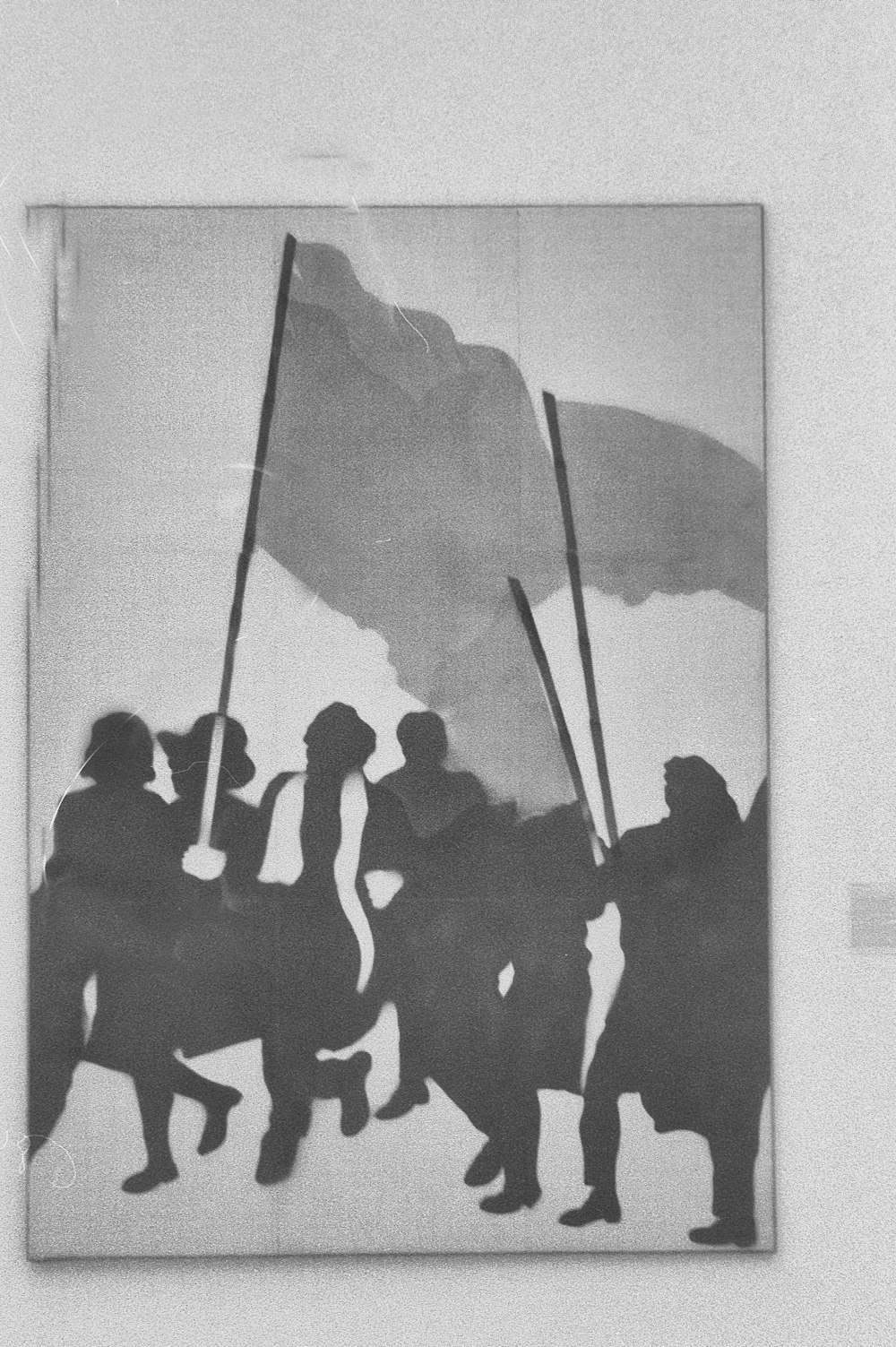 a black and white photo of a group of people holding flags