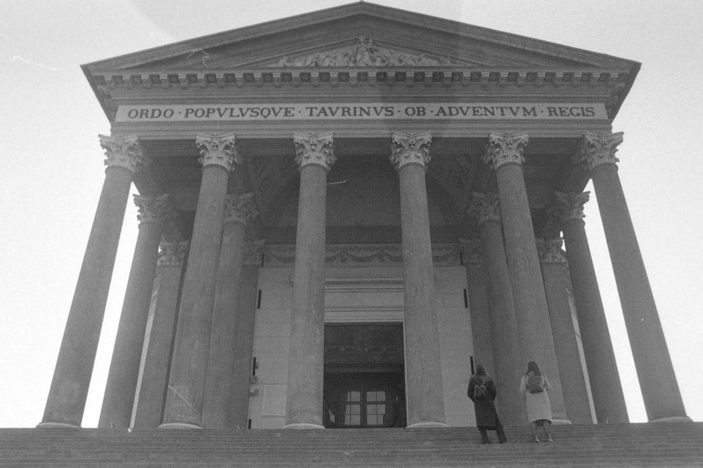 two people standing on the steps of a courthouse