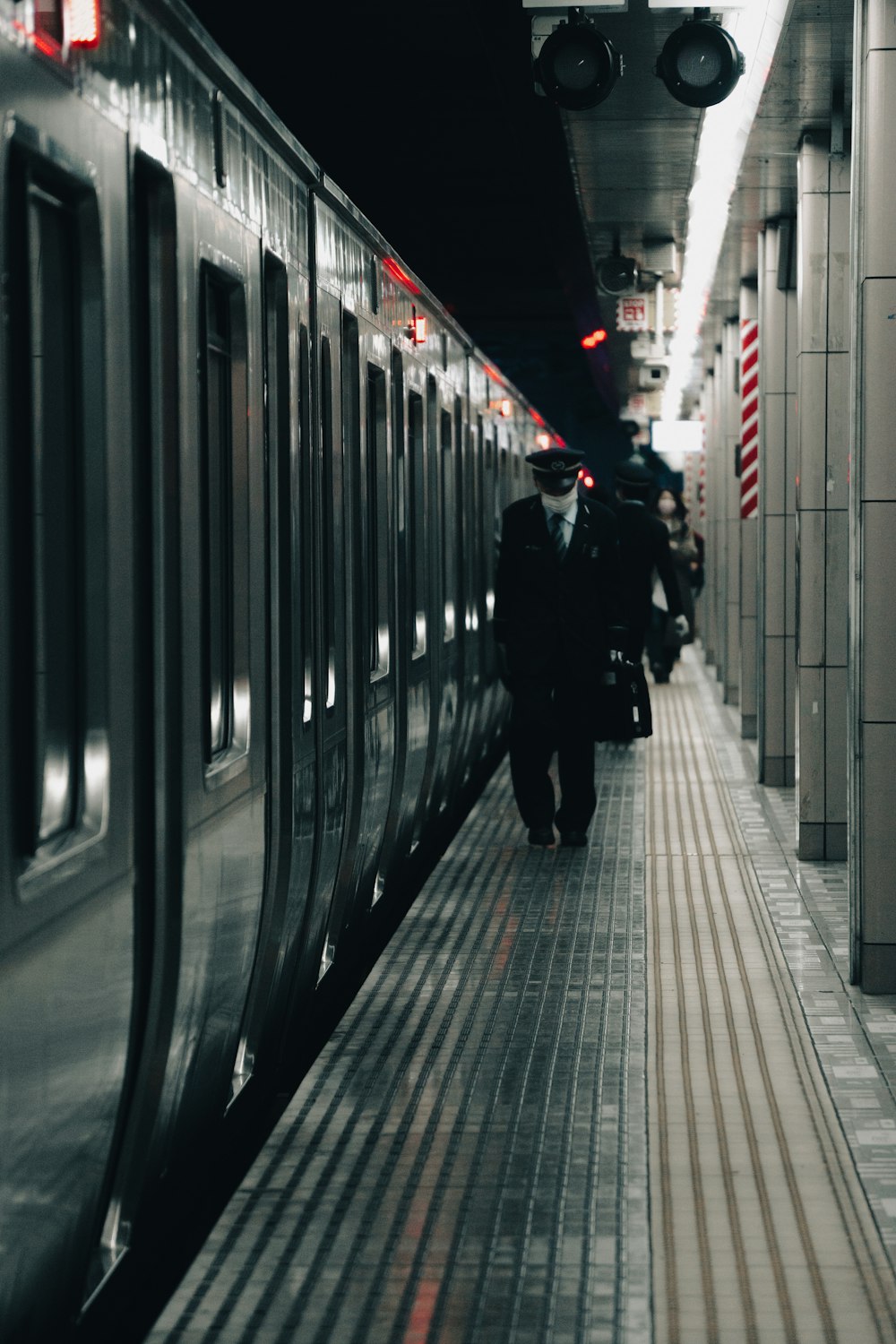 a train pulling into a train station next to a platform