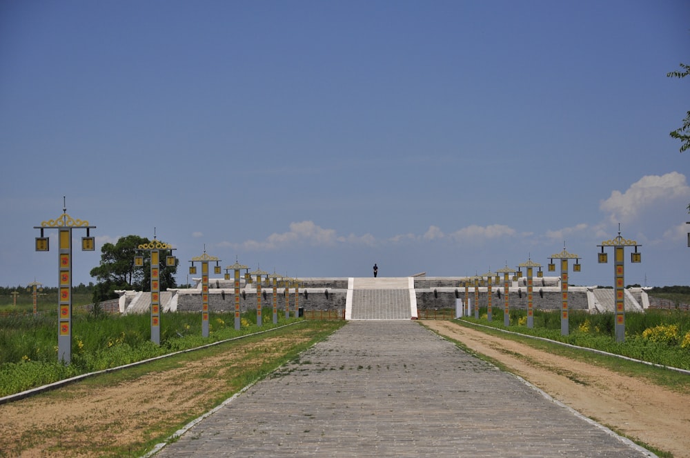 a walkway leading to a gate with crosses on it