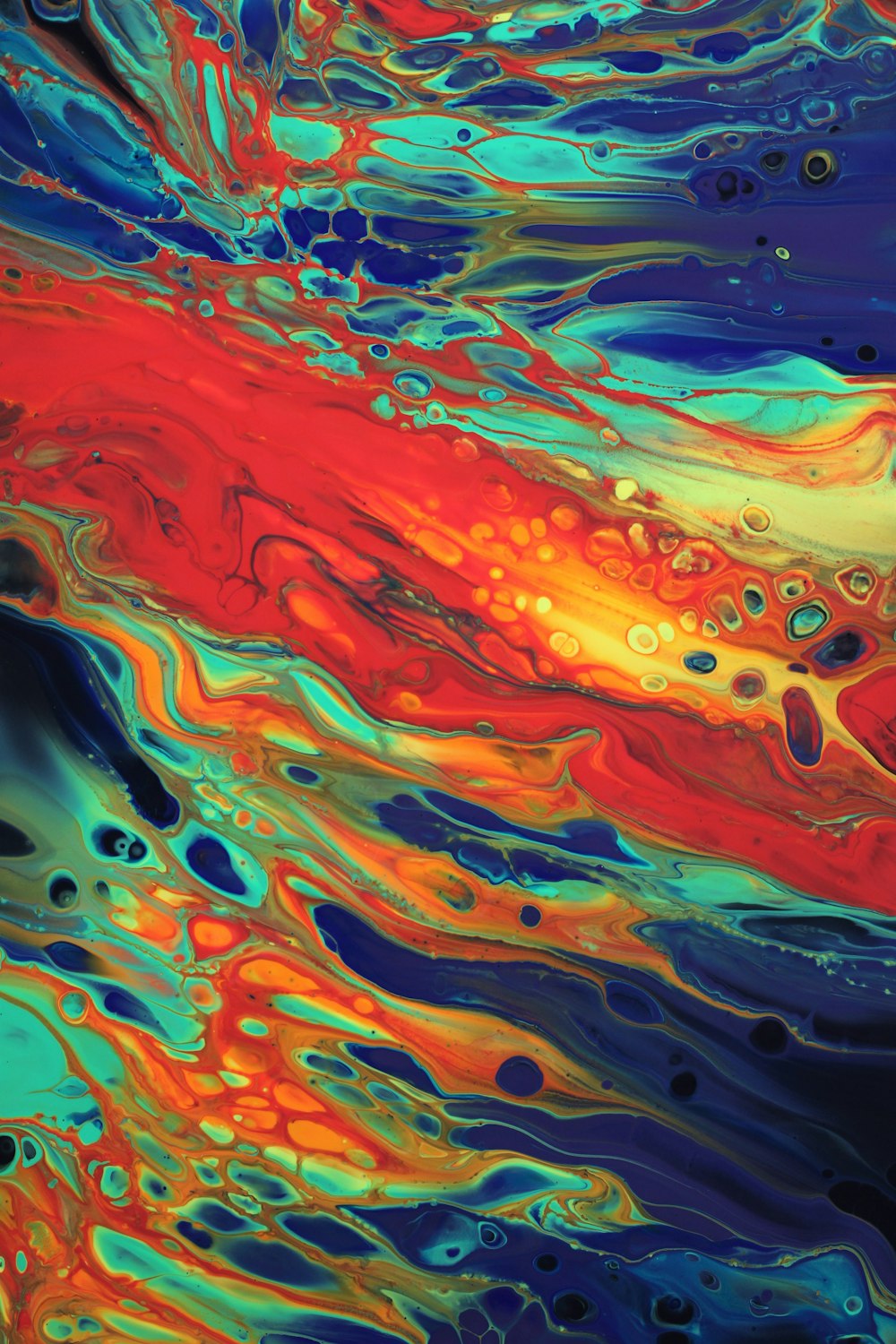 a colorful liquid painting with a red, yellow, and blue swirl