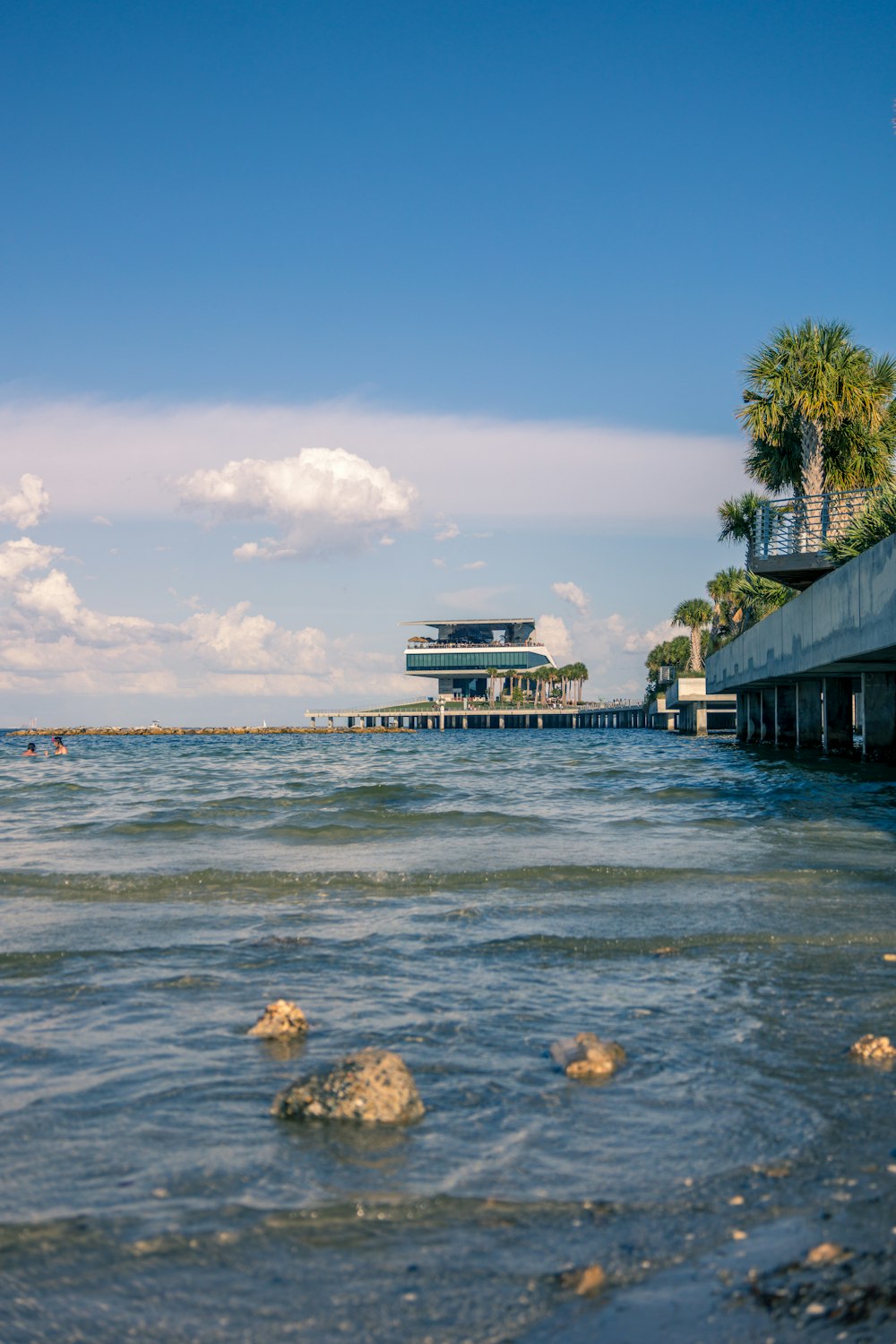 a body of water with a building in the background