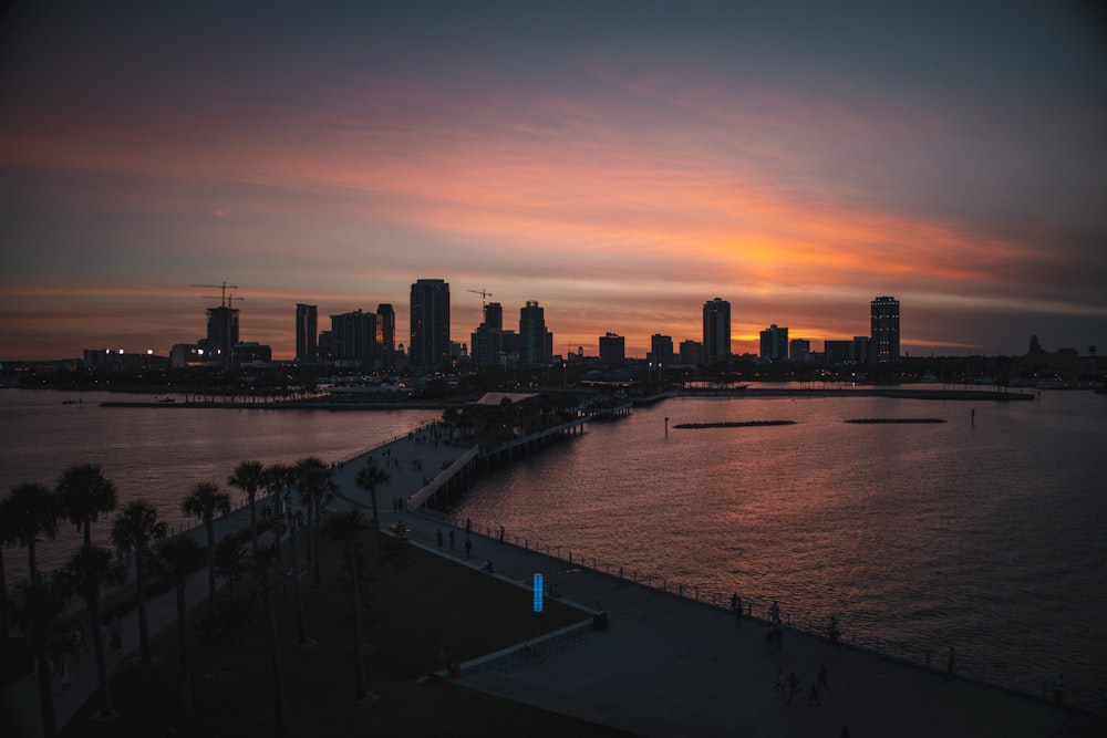 a sunset view of a city and a body of water