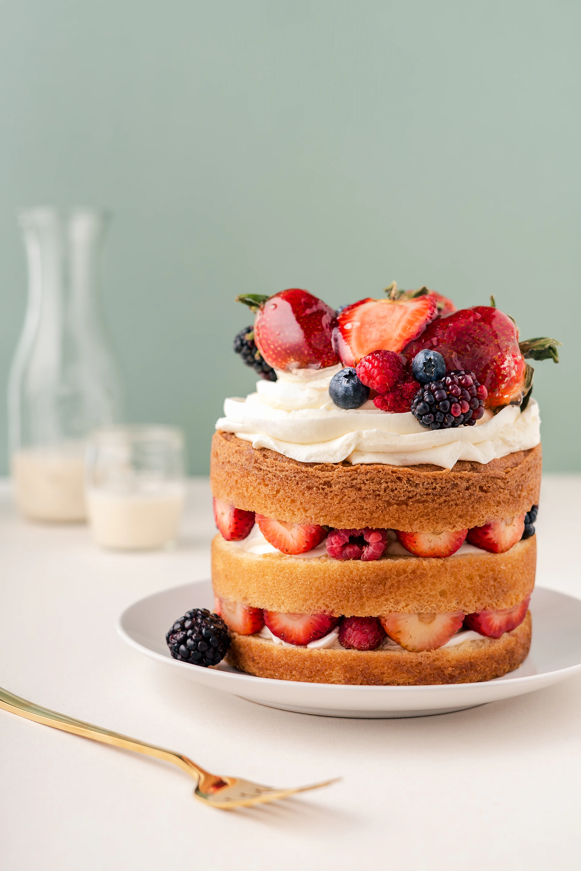 a cake with strawberries and blueberries on a plate