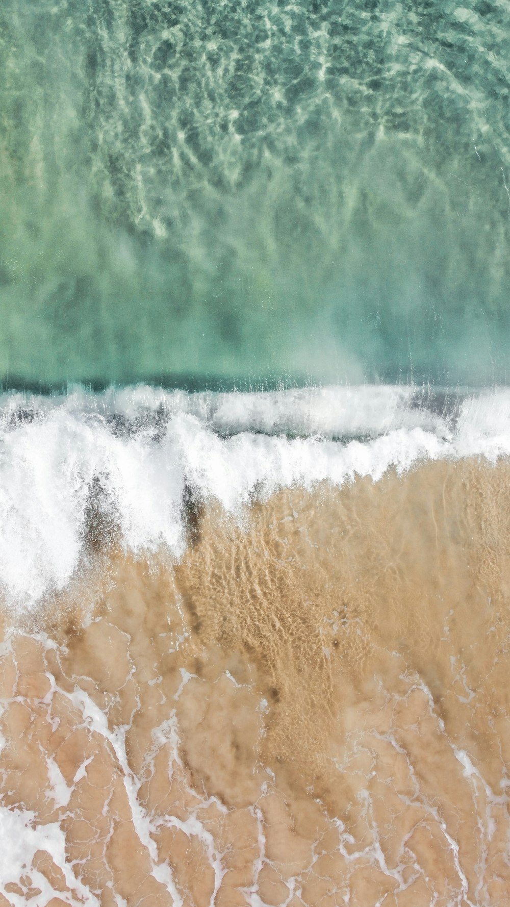 a person riding a surfboard on top of a wave