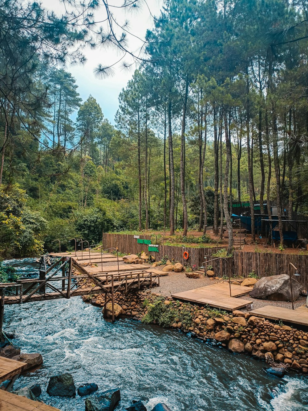 a small wooden bridge over a small river