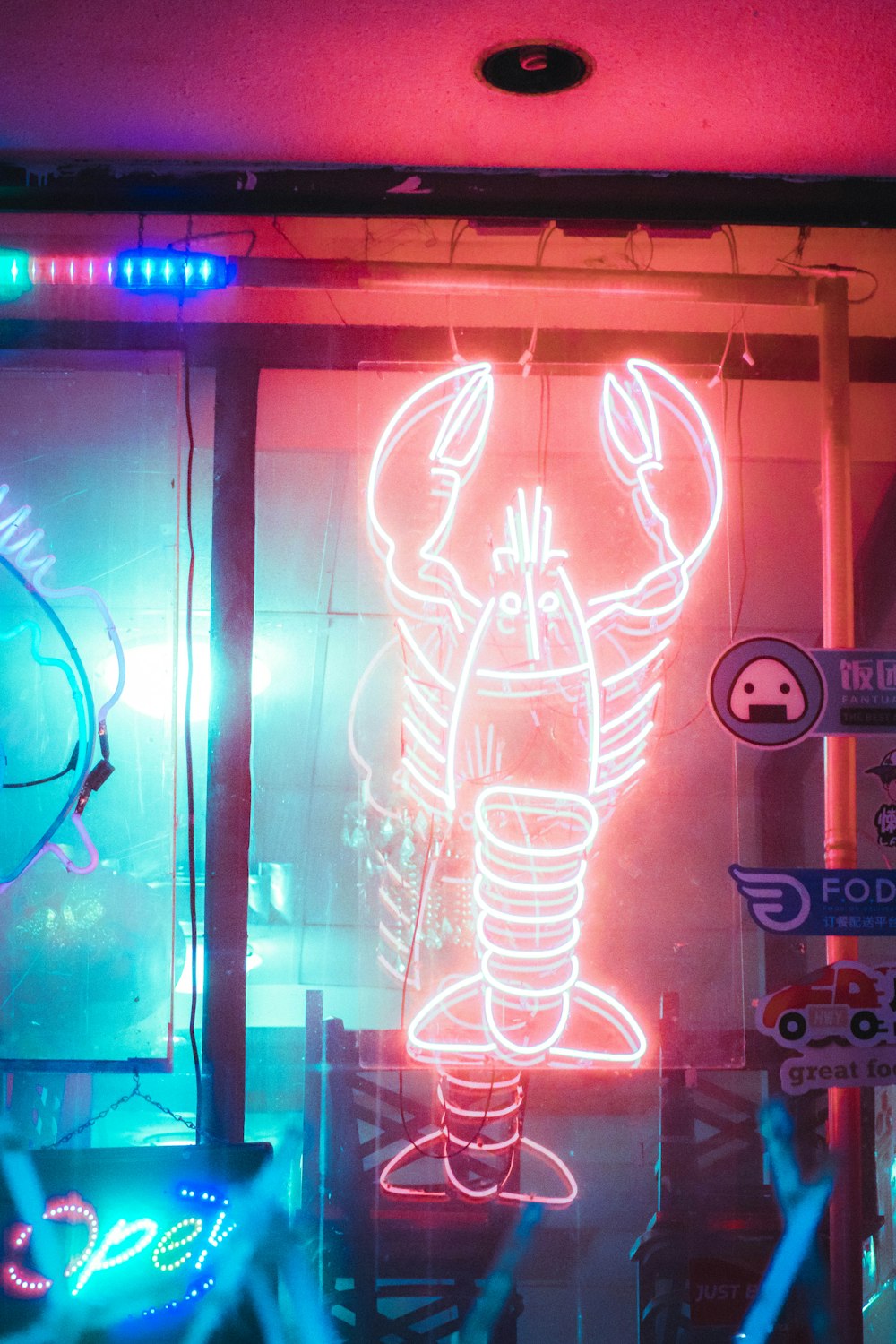 a neon lobster on display in a store window