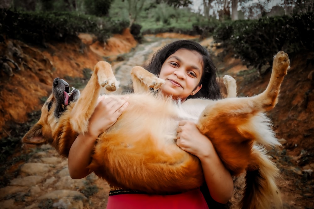 a woman holding a large dog in her arms