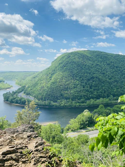a scenic view of a river surrounded by mountains