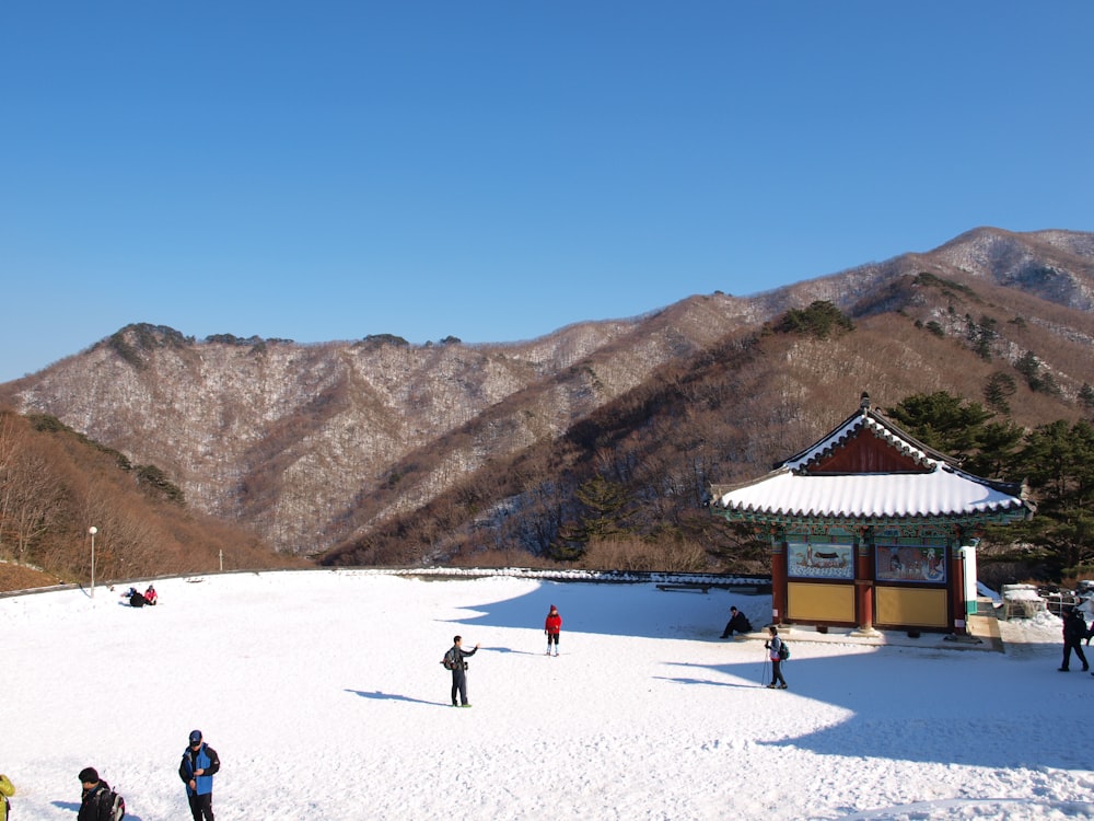 a group of people standing on top of a snow covered slope